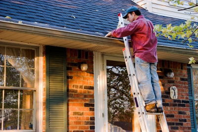 Man Fixing Roof In Houston, TX